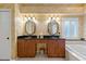 Bathroom with a large vanity, soaking tub and window with plantation shutters at 1383 Dartford Dr, Tarpon Springs, FL 34688