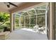Relaxing screened porch with wicker furniture and tree views at 1383 Dartford Dr, Tarpon Springs, FL 34688