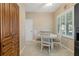 Bright breakfast nook with table and chairs, wood cabinets, and window with plantation shutters at 1383 Dartford Dr, Tarpon Springs, FL 34688
