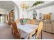 Sunlit dining room with a chandelier, and views into the living room and kitchen at 8440 Maybelle Dr, Weeki Wachee, FL 34613