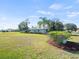 House with a large grassy yard and manicured landscaping at 8440 Maybelle Dr, Weeki Wachee, FL 34613