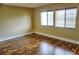 Bedroom featuring wood flooring and natural light at 1873 Mazo Mnr # T5, Lutz, FL 33558