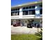 Charming exterior with ample parking, golf carts, and landscaping at 1873 Mazo Mnr # T5, Lutz, FL 33558