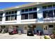 Charming condo building with multiple windows and golf carts parked in front at 1873 Mazo Mnr # T5, Lutz, FL 33558