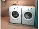 Modern laundry room equipped with a Whirlpool washer and dryer at 1873 Mazo Mnr # T5, Lutz, FL 33558
