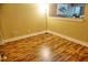 Inviting living room featuring wood flooring and a modern floor lamp at 1873 Mazo Mnr # T5, Lutz, FL 33558