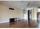 Bright living room featuring laminate wood flooring and view to the bathroom and staircase at 1873 Mazo Mnr # T5, Lutz, FL 33558