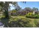Brick house with solar panels and landscaped yard at 4486 Berisford Blvd, Palm Harbor, FL 34685