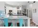 Spacious kitchen with white cabinets, quartz countertops, and teal accents at 4486 Berisford Blvd, Palm Harbor, FL 34685