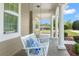 Charming front porch with a white swing and columns at 10110 Weeks Dr, Brooksville, FL 34601