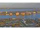 Stunning aerial view showcasing waterfront condos amidst lush greenery and tranquil bay waters, surrounded by luxury homes at 770 Island Way # N302, Clearwater, FL 33767