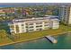 Aerial view of condo building, showcases waterfront living with nearby docks and scenic views at 770 Island Way # N302, Clearwater, FL 33767