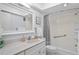 Bright bathroom features a vanity with sink, large mirror, and shower and tub combo at 770 Island Way # N302, Clearwater, FL 33767