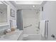 Clean and bright bathroom with white fixtures and a shower-tub combination at 770 Island Way # N302, Clearwater, FL 33767
