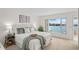 Cozy bedroom with a serene view of the waterfront and ample natural light at 770 Island Way # N302, Clearwater, FL 33767
