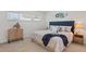 Comfortable bedroom featuring a queen bed, stylish headboard, and warm lighting at 770 Island Way # N302, Clearwater, FL 33767
