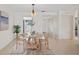 Cozy dining room with natural wood table, tile floors and bright natural lighting at 770 Island Way # N302, Clearwater, FL 33767