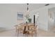 Dining area with a round table, stylish chairs, and elegant beach-themed decor at 770 Island Way # N302, Clearwater, FL 33767