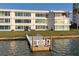 Waterfront view of condo building with a private dock, blending convenience with scenic beauty at 770 Island Way # N302, Clearwater, FL 33767