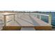 Modern dock with sturdy white railings, offering a peaceful waterfront view and easy access to the water at 770 Island Way # N302, Clearwater, FL 33767