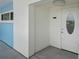 Building entrance with light blue exterior and a front door with an oval window at 770 Island Way # N302, Clearwater, FL 33767