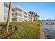 Waterfront property with lush grass extending to the water's edge and private pier at 770 Island Way # N302, Clearwater, FL 33767