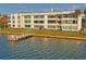 Waterfront condo building with grassy lawn, private dock, and beautiful blue water views at 770 Island Way # N302, Clearwater, FL 33767