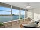 Living room offering beautiful water views and natural light through expansive windows at 770 Island Way # N302, Clearwater, FL 33767