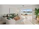 Bright living room with neutral tones, modern furnishings, and beautiful water view at 770 Island Way # N302, Clearwater, FL 33767