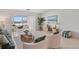 Bright living room with tile floors, cozy seating, and a sunroom with waterfront views at 770 Island Way # N302, Clearwater, FL 33767