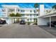 Modern condo building includes covered parking with lush landscaping and nearby walkways at 770 Island Way # N302, Clearwater, FL 33767