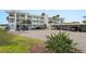 Condo building features covered parking with room for multiple vehicles, plus green landscaping at 770 Island Way # N302, Clearwater, FL 33767