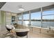 Sunroom with tile floors, shelves, and large windows offering scenic water views at 770 Island Way # N302, Clearwater, FL 33767