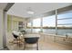 Inviting sunroom featuring tile flooring and floor-to-ceiling windows with scenic water views at 770 Island Way # N302, Clearwater, FL 33767