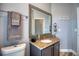 Charming bathroom with a granite-topped vanity, a decorative mirror, and nautical-themed accents at 13753 Judy Ave, Hudson, FL 34667