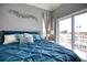 Bright bedroom with a slider door and a comfortable bed with accent pillows at 13753 Judy Ave, Hudson, FL 34667