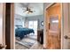 Relaxing bedroom with a ceiling fan and ensuite bathroom entrance at 13753 Judy Ave, Hudson, FL 34667
