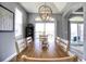 Spacious dining room with gray walls, a modern light fixture, and sliding doors at 13753 Judy Ave, Hudson, FL 34667