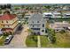 Three-story home with well-maintained front yard, brick driveway, and a black SUV parked on the side at 13753 Judy Ave, Hudson, FL 34667