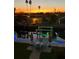 Waterfront patio and dock area lit up at twilight, featuring a canal view and outdoor seating at 13753 Judy Ave, Hudson, FL 34667