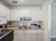 Kitchen with double sink and white cabinets at 11935 Bayonet Ln # 0, New Port Richey, FL 34654