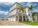 Three-story home with three-car garage and palm trees at 13753 Judy Ave, Hudson, FL 34667