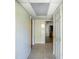 Clean hallway with tile flooring and access to kitchen at 4252 Courier Ln, Holiday, FL 34691