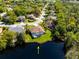 Aerial view of a home with a private pool and lake access in a lush, green neighborhood at 21312 Preservation Dr, Land O Lakes, FL 34638