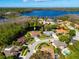 Aerial view of a lovely home on a waterfront lot, with beautiful green surroundings at 21312 Preservation Dr, Land O Lakes, FL 34638