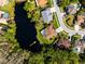 Aerial view of a beautiful home situated on a waterfront lot with lush landscaping at 21312 Preservation Dr, Land O Lakes, FL 34638