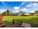 Spacious backyard featuring lush green grass, mature trees, and views of the home at 21312 Preservation Dr, Land O Lakes, FL 34638