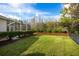 The manicured backyard shows off a pond with a wooden fence and grass at 21312 Preservation Dr, Land O Lakes, FL 34638