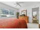 Well-lit bedroom with a window, dresser, and a view into another room at 21312 Preservation Dr, Land O Lakes, FL 34638