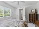 Bedroom features a window, closet, and view into the bathroom from the open door at 21312 Preservation Dr, Land O Lakes, FL 34638
